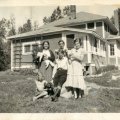 Belva and Goldie Nelson with Rusty in front of lodge at Nelsons Resort early 1930s
